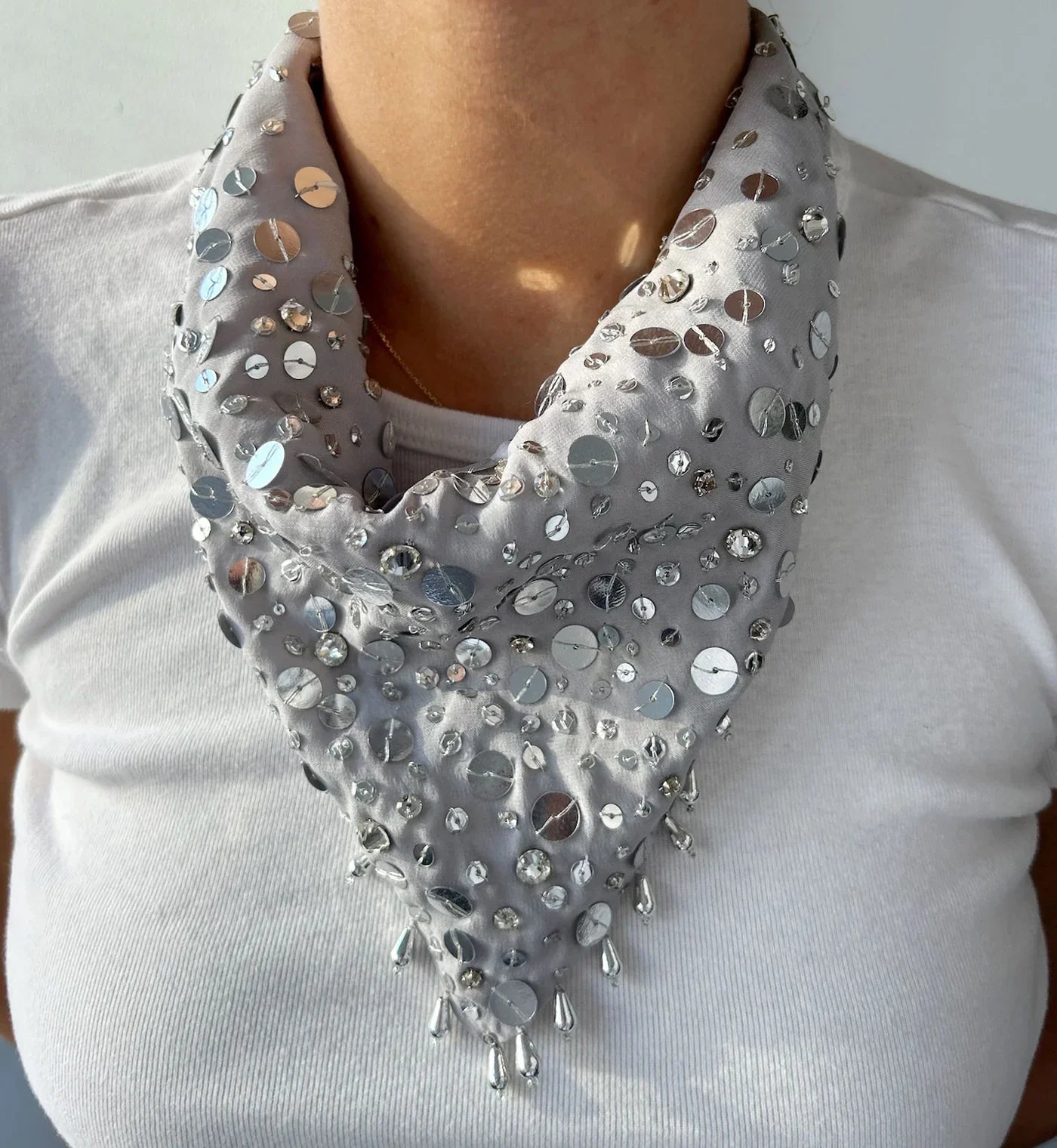 embroidered gray neck scarf worn over a gray t-shirt