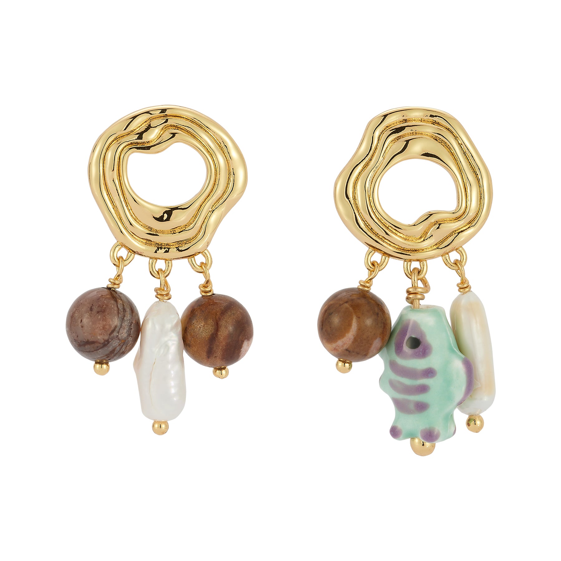 Gold earrings with beads and a small figurine on a white background