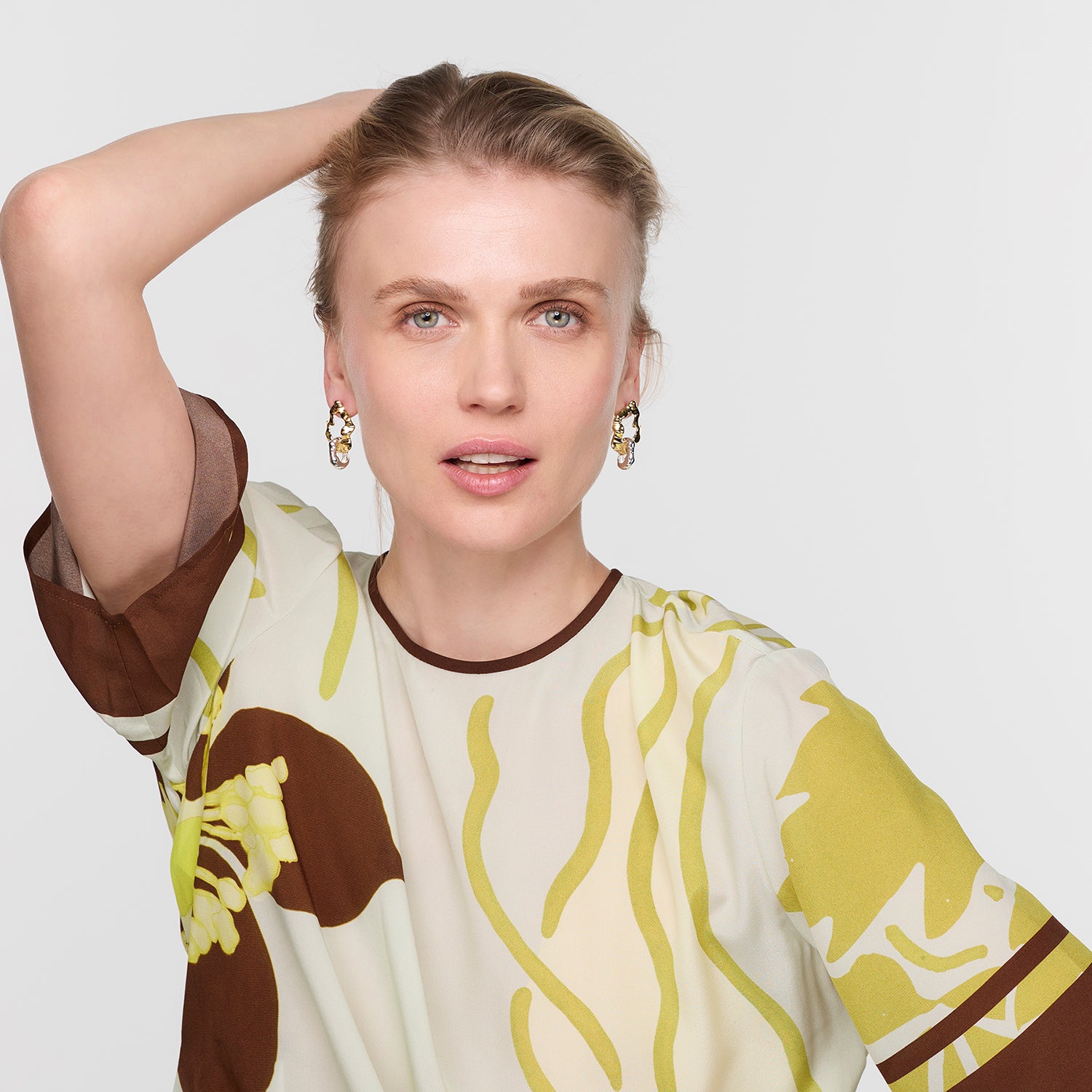 Woman wearing a patterned dress with a plain background