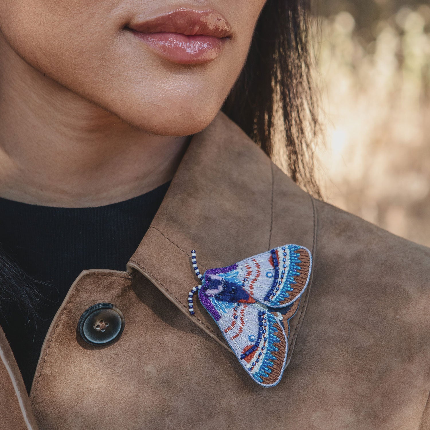Purple and Blue Bead Embroidered Moth Brooch Styled on Model's Jacket