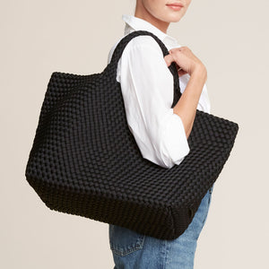 Woven Black Neoprene Tote Bag Styled on Model in Jeans and White Shirt