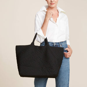 Woven Black Neoprene Tote Bag Styled on Model in Jeans and White Shirt