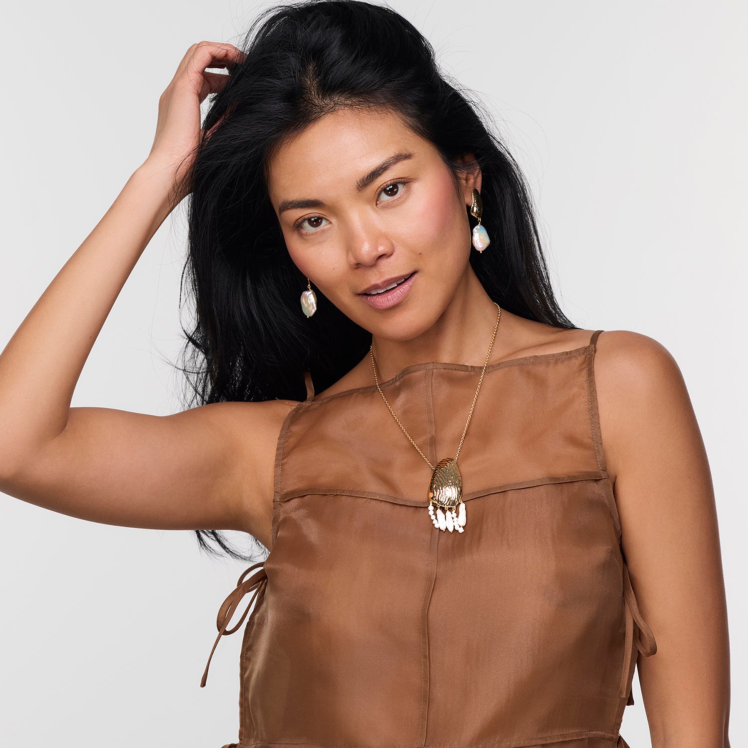 Model wearing Gloria Drop Earrings and Gloria Necklace