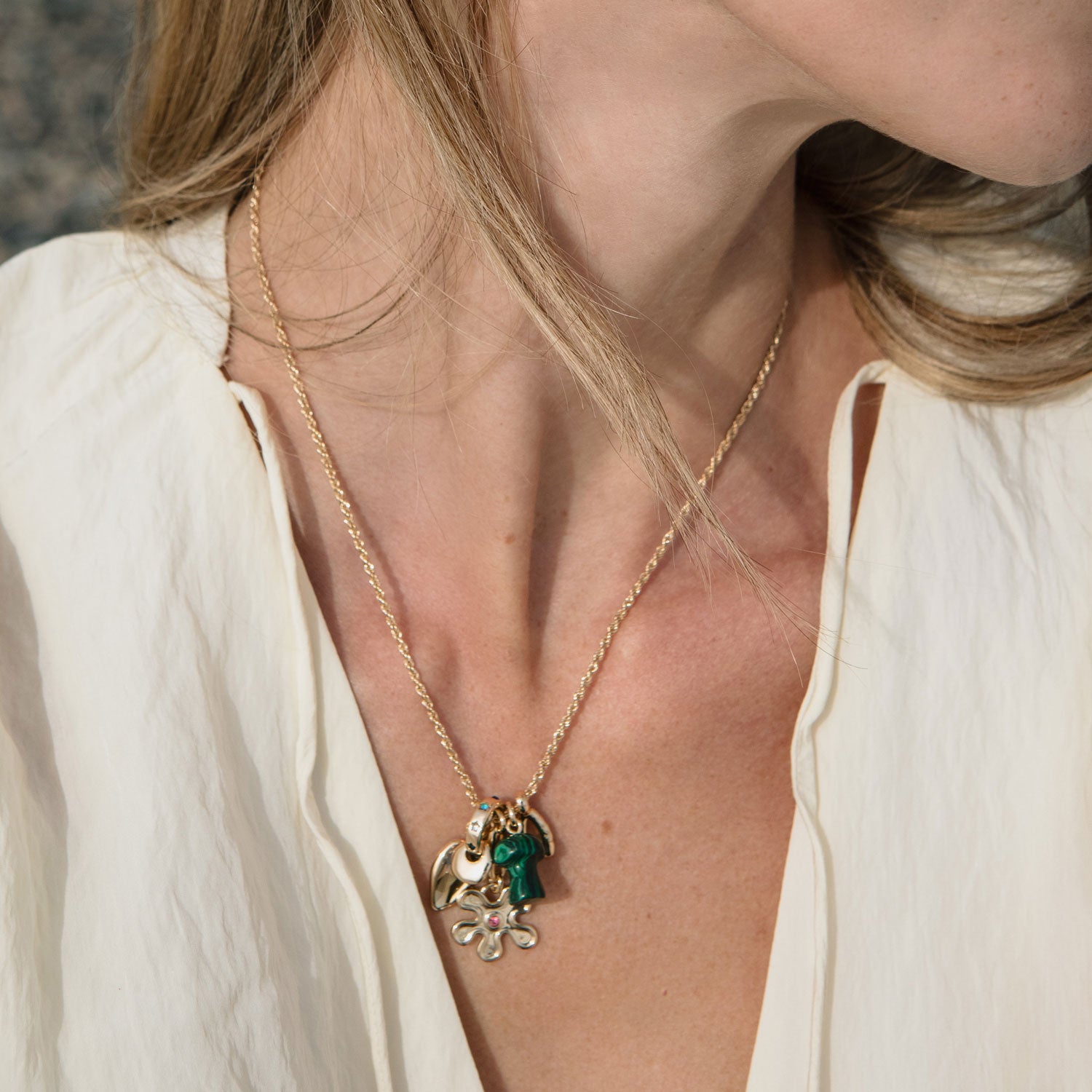 Gold, Stone, and Crystal Pendant Charm Necklace Styled on Model