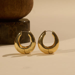 Gold Hoop Earrings Staged on Cream Background with Brown and Black Marble Vase