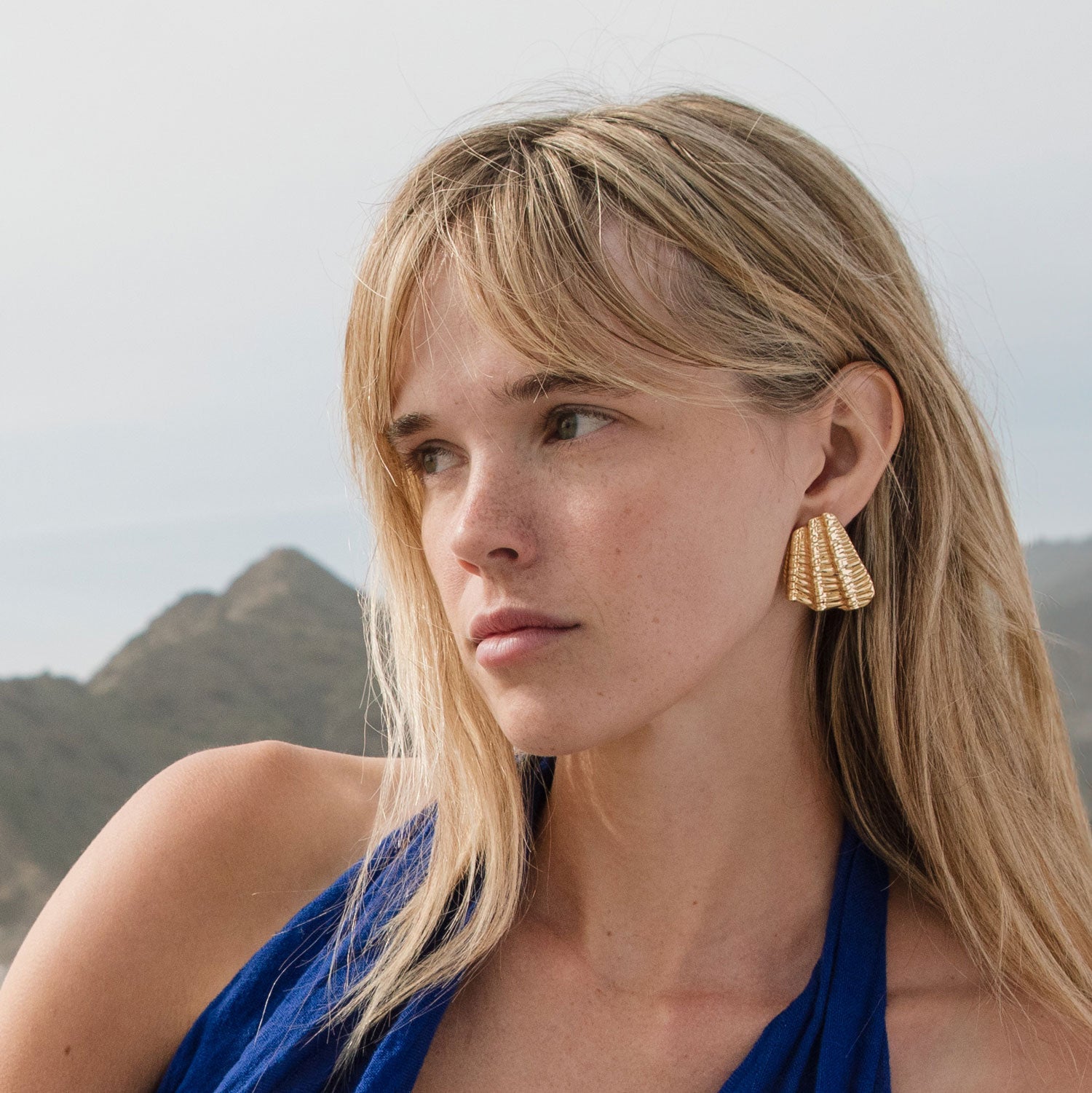 Gold Shell Stud Earrings Styled on Model