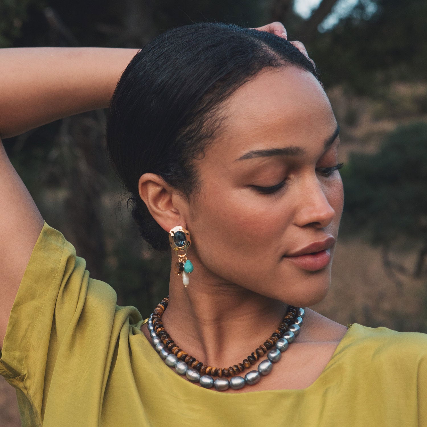 Grey Freshwater Pearl Strand Necklace Styled on Model with Brown Beaded Strand and Charm Drop Earrings