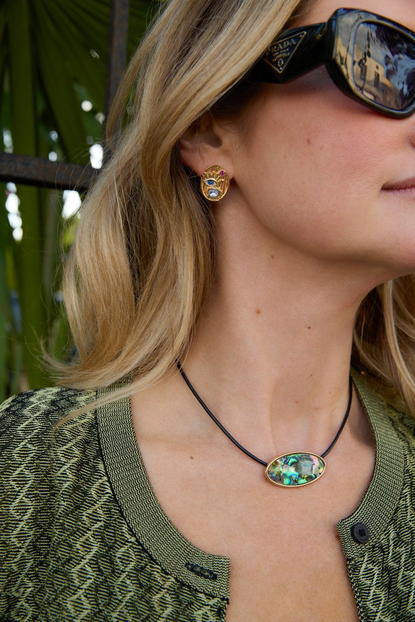 Maggie wearing mother of peal necklace on cord.