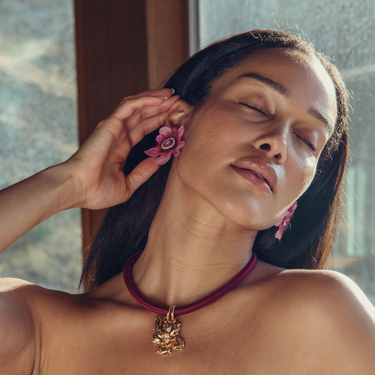 Red Cord Necklace with Gold Flower and Heart Charms Styled on Model