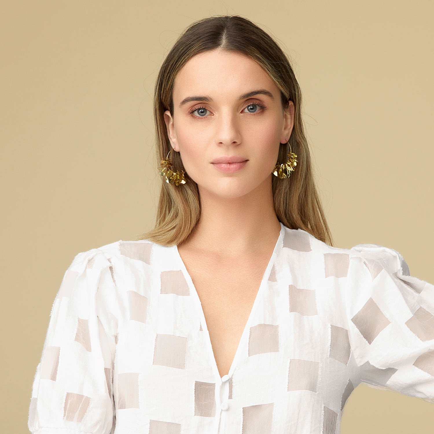 Metallic Gold Wavy Sequins on Thin Gold Hoop on Blonde Model with White Blouse On