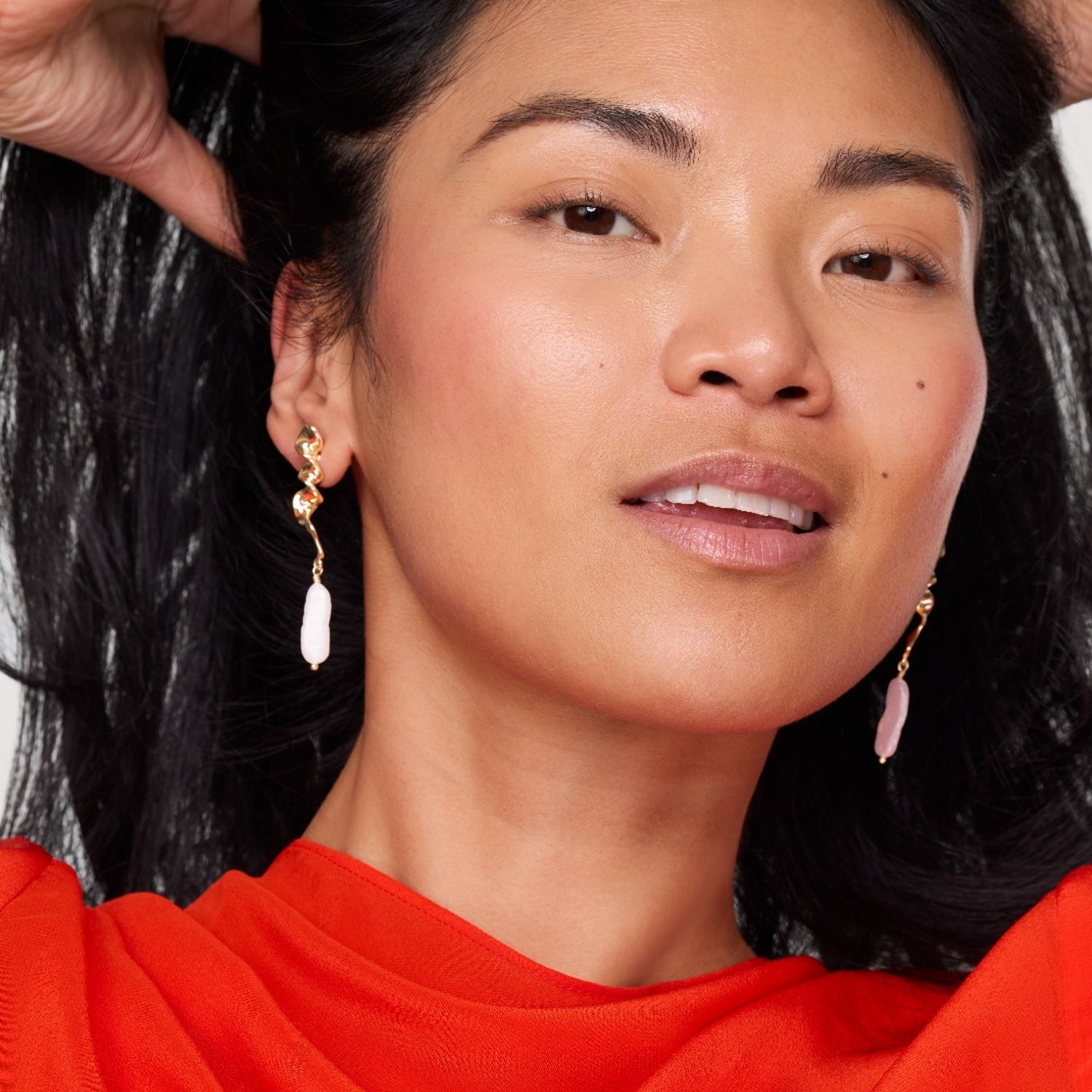 Close-up of a woman wearing earrings with a blurred background