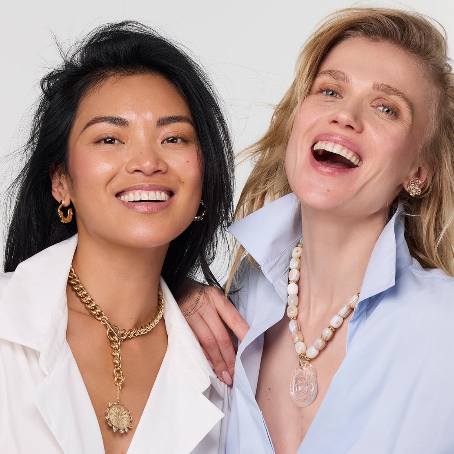 Two women wearing necklaces against a white background