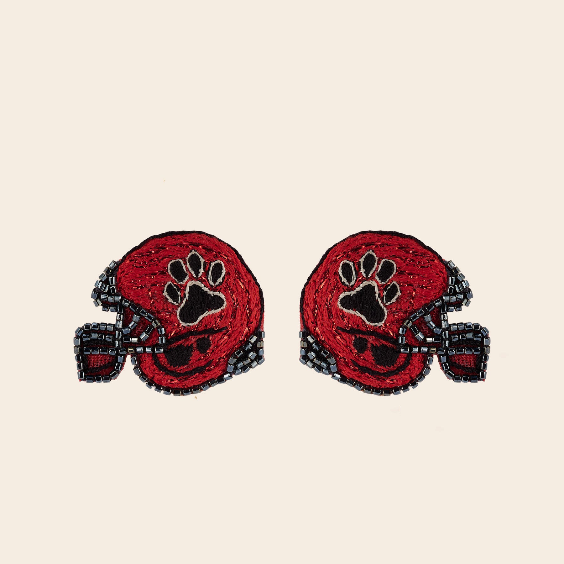 Red and Black Paw Print Embroidered Football Helmet Stud Earrings on Tan Background