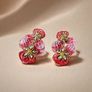 Red and Pink Flower Double Drop Earrings with Crystals and Beads on Flat Cream Background