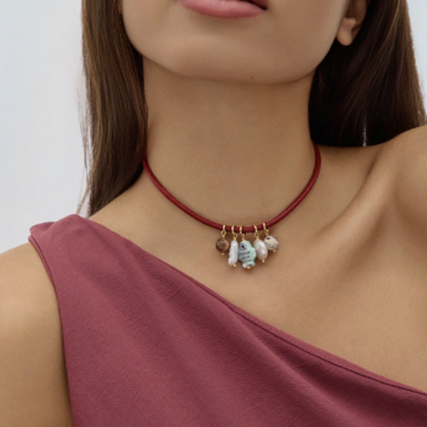 Charm Necklace with red cord on model against white background