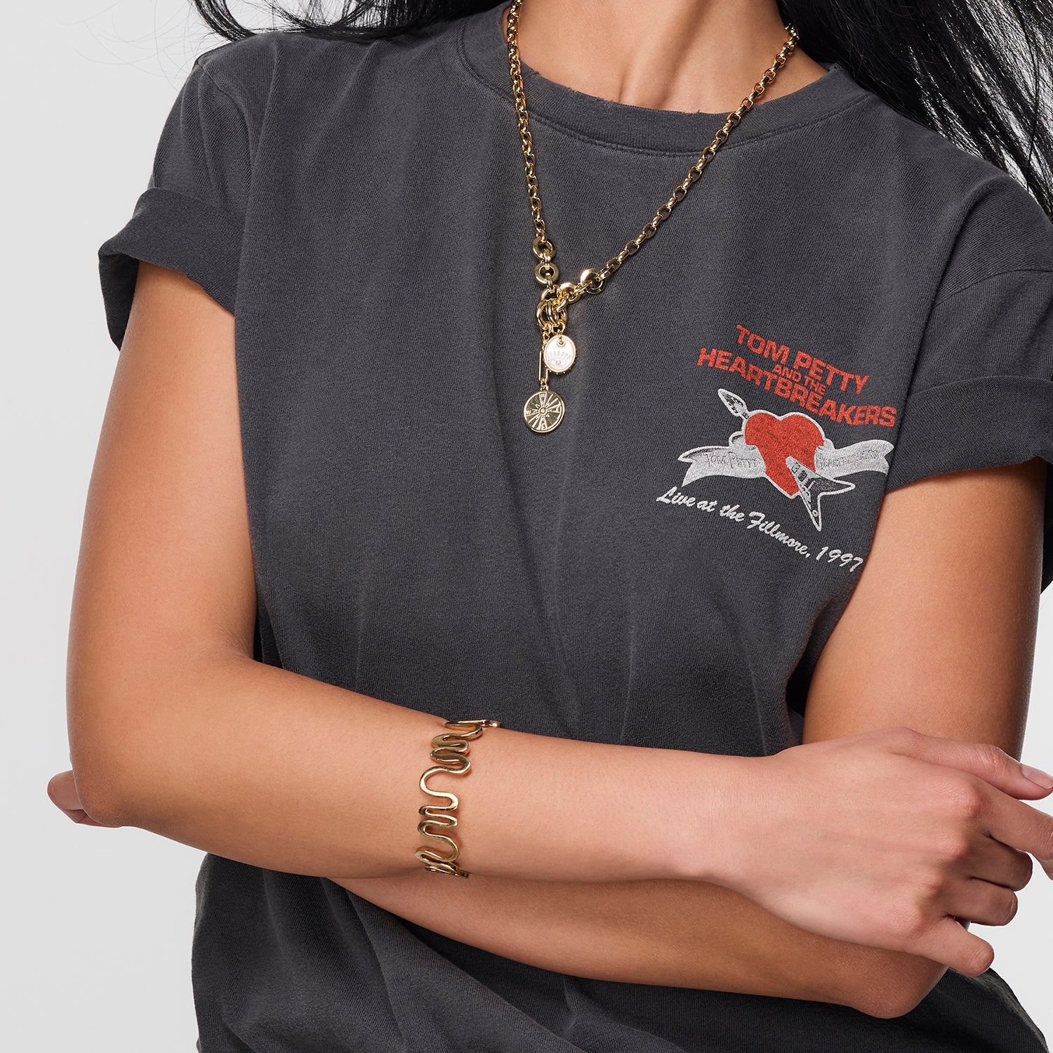 Model wearing gold chain necklace against white background