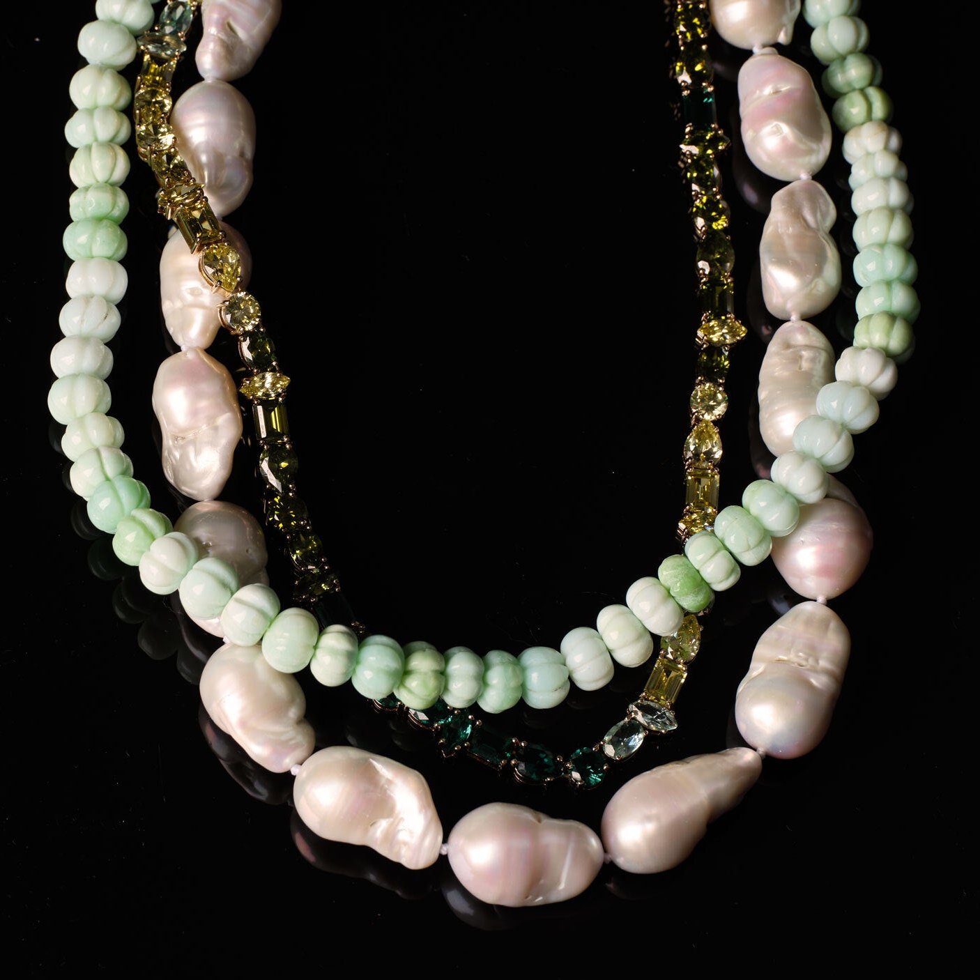 White Pearl Strand Necklace Styled with Green Crystal Tennis Necklace and Green Beaded Necklace on Black