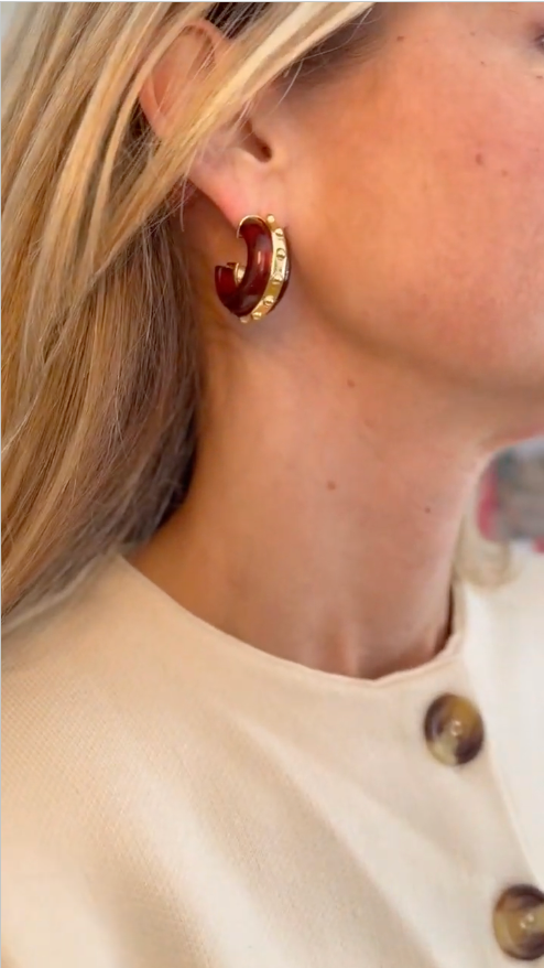 Model wearing cream knit button down set explaining brown and gold hoop earrings
