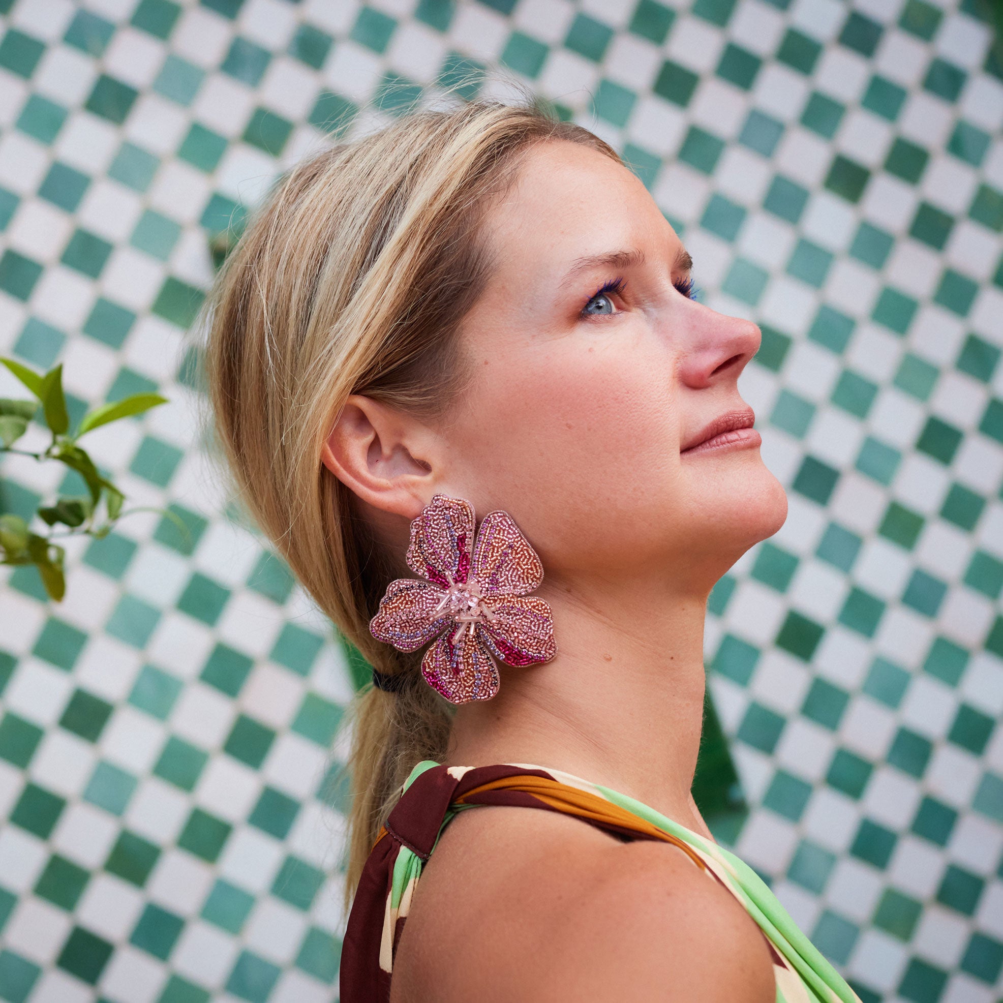 beaded pink and gold large flower stud earring worn by model in profile