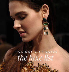 "Holiday Gift Guide the luxe list" text overlay on an image of a woman wearing dangle earrings with pearls semi precious stones and crystals