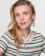 Woman wearing a striped shirt with a plain background