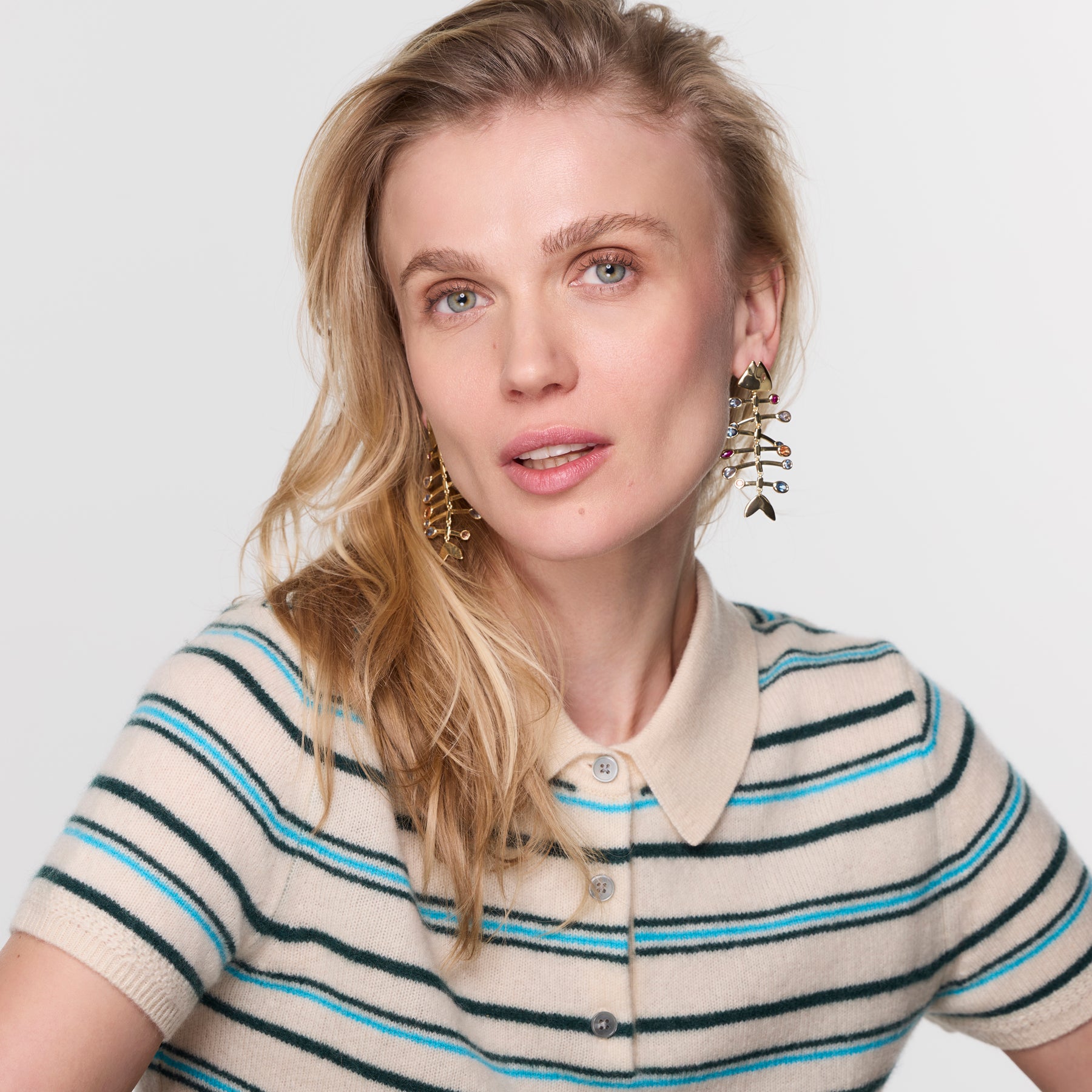 Woman wearing a striped shirt with a plain background