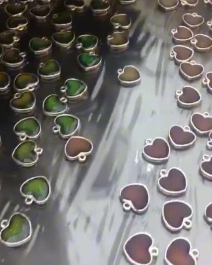 Heart-shaped charms being produced on an assembly line
