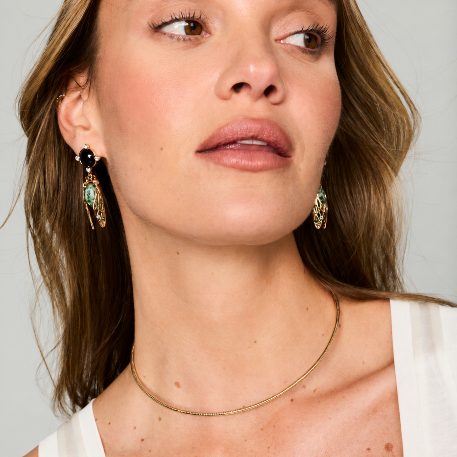 Gold-tone herringbone necklace featuring a delicate chain, adjustable extender, hook clasp on model