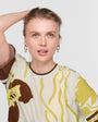 Woman wearing a patterned dress with a plain background
