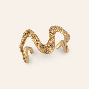 Antiqued Gold Cuff Bracelet on Tan Background