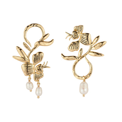 A pair of gold-toned floral dangle earrings with textured leaf and flower motifs and small white pearl drops, shown on a plain white background.