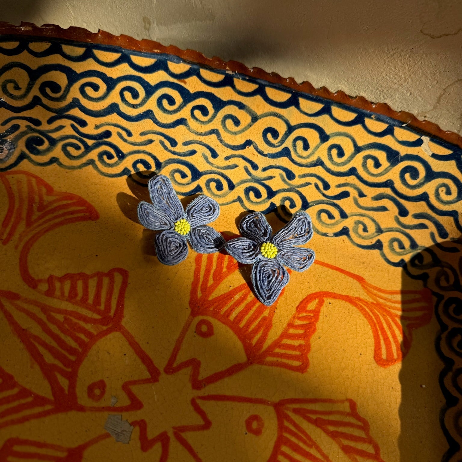 Decorative butterfly stamp on a textured surface with intricate patterns