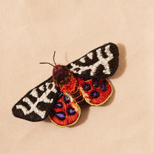 Beaded and Embroidered Brown and Ivory Speckled and Orange Accented Butterfly Brooch on Cream Flat Background