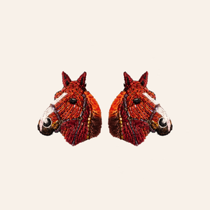 Brown and White Horse Stud Earrings Styled on Cream Background