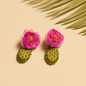 Embroidered and Beaded Pink Flower Cactus Drop Earrings Staged with Palm on Tan Surface