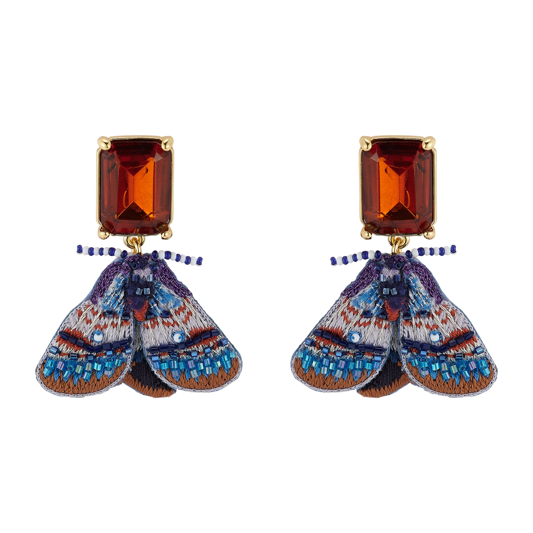 Pair of Purple and Blue Moth Earrings Suspended by Faceted Amber Crystals on Flat White Background