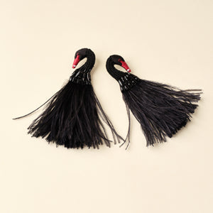 Black Beaded and Feather Swan Earrings on Tan Background