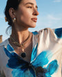 Gold Hoop Earrings Styled on Model with Black and Gold Charm Necklace