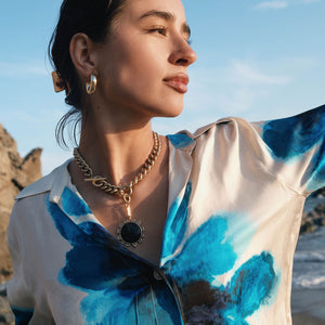 Gold Hoop Earrings Styled on Model with Black and Gold Charm Necklace