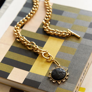 Black Globe Charm Chain Pendant Charm Necklace Styled on a Print Book