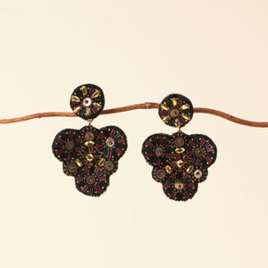 Black and Gold Beaded Double Drop Earrings Staged on Branch with Tan Background