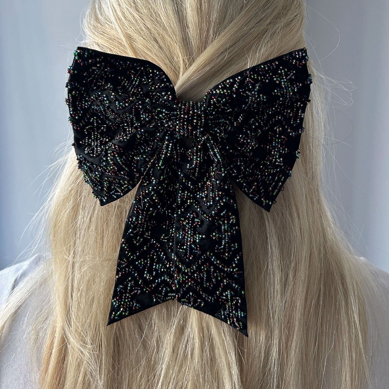 Black Hair Bow with Multi-Colored Beading Styled in Model's Hair