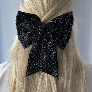 Black Hair Bow with Multi-Colored Beading Styled in Model's Hair