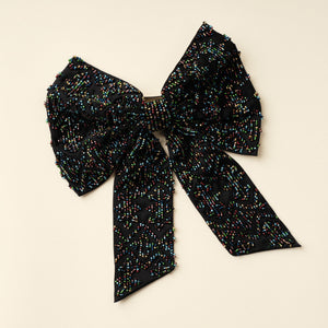 Black Hair Bow with Multi-Colored Beading on Tan Background