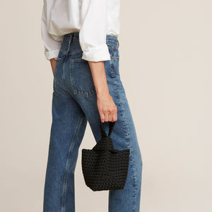 Black Woven Handbag Styled on Model in Jeans and White Shirt