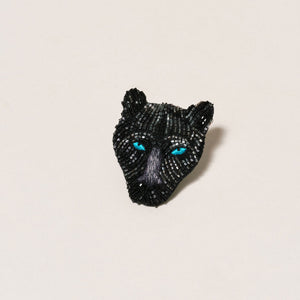 Black and Blue Beaded and Embroidered Panther Brooch on Tan Background
