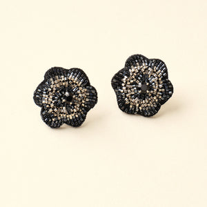 Black and Silver Beaded Flower Stud Earrings on Tan Background