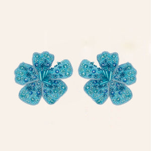 Blue Beaded Flower Stud Earrings on Tan Background