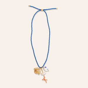 Blue Chord Pendant Charm Necklace on Cream Background