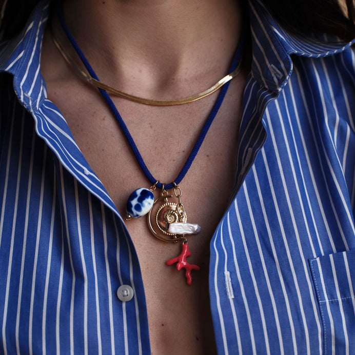 Blue Chord Pendant Charm Necklace Styled on Model with Gold Herringbone Necklace